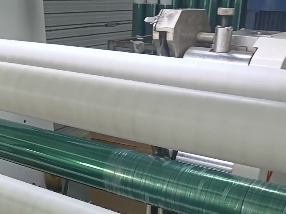 Automated circular lathe log slitter cutting directly through pre-wound master adhesive tape rolls for rapid turnaround